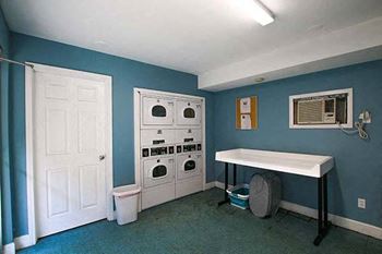 a laundry room with a white washer and dryer